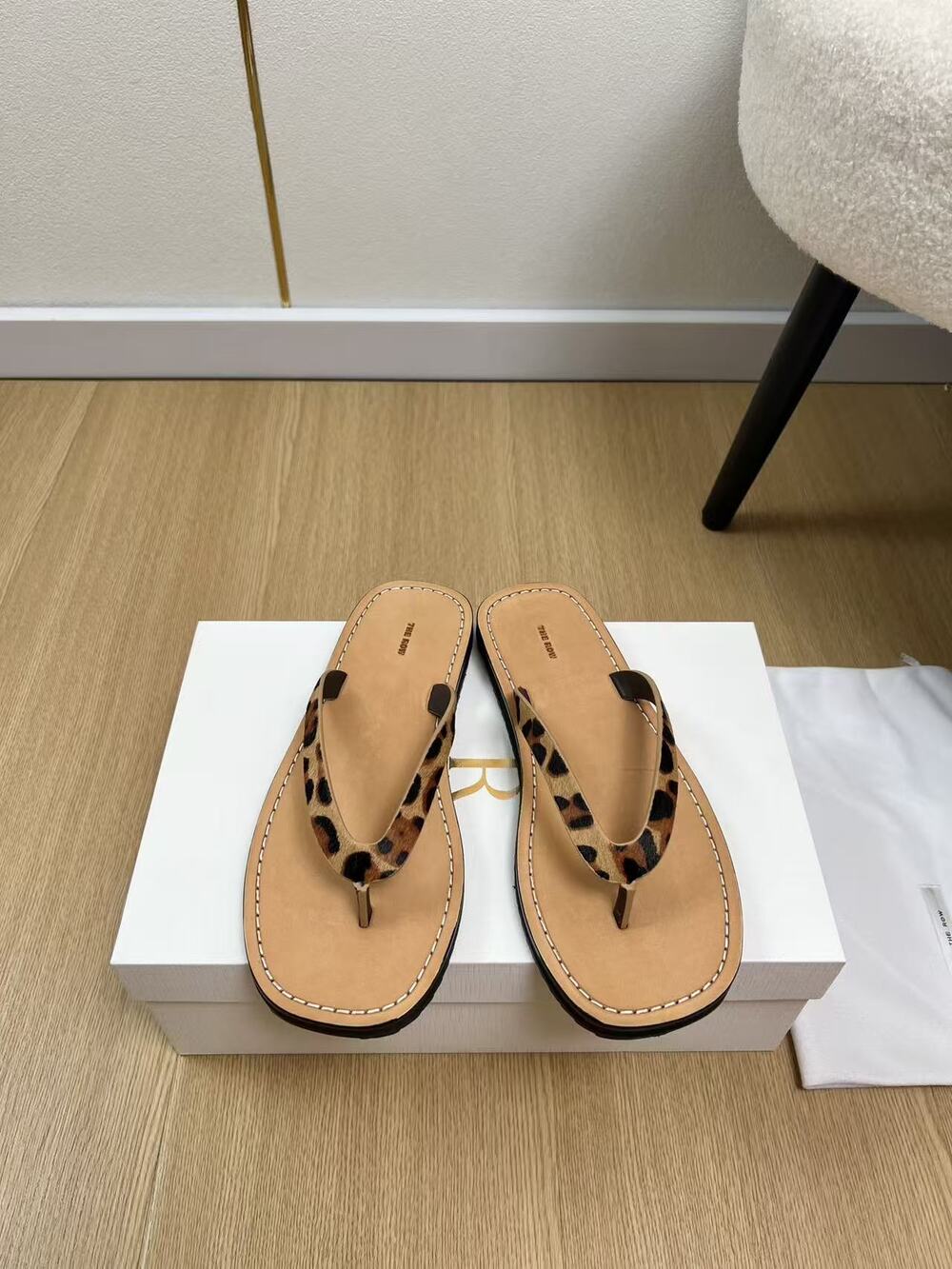 The Row Tan Leather Black Strap FlipโFlop Thong Sandals